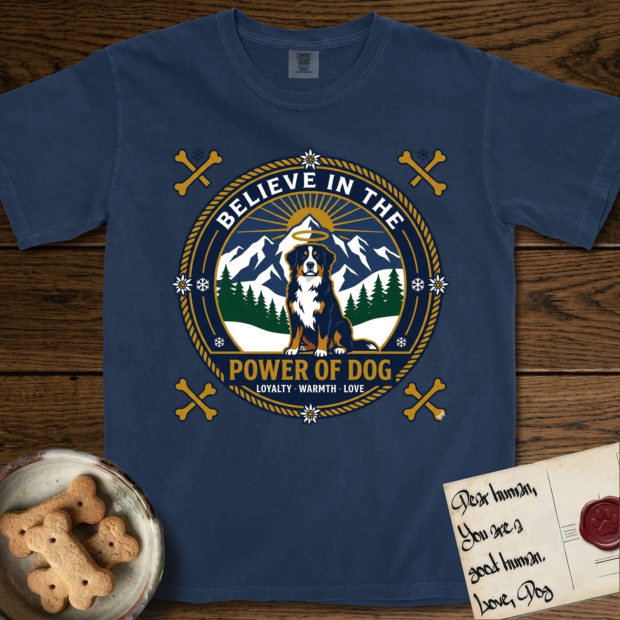 Believe in the Power of Dog Bernese Mountain Dog T-Shirt flat lay in True Navy, featuring a circular national-park-style badge with a haloed Bernese Mountain Dog, a mountain scene, a rope border, and the words Loyalty, Warmth, Love.