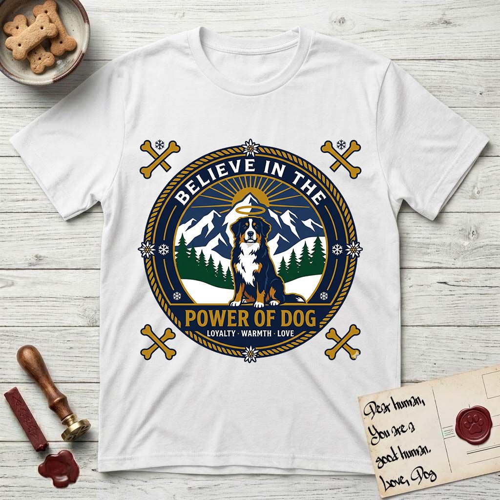 Believe in the Power of Dog Bernese Mountain Dog T-Shirt flat lay in White, featuring a circular national-park-style badge with a haloed Bernese Mountain Dog, a mountain scene, a rope border, and the words Loyalty, Warmth, Love.