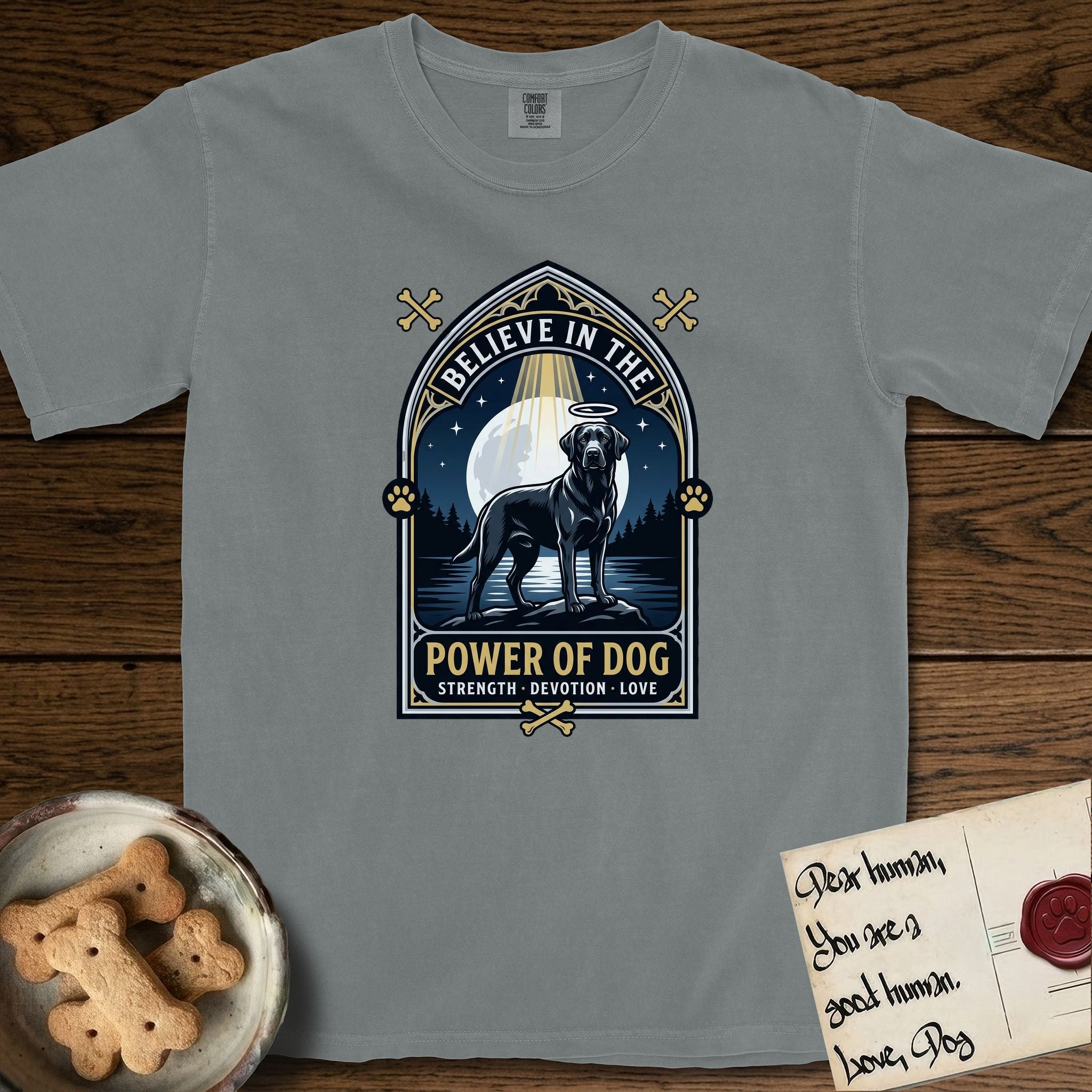Believe in the Power of Dog Black Lab T-Shirt flat lay in Granite, featuring a dramatic gothic-arch badge with a moonlit Black Lab on a rock above still water, a beam of light through the arch, and the words Strength, Devotion, Love.