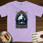 Believe in the Power of Dog Black Lab T-Shirt flat lay in Orchid, featuring a dramatic gothic-arch badge with a moonlit Black Lab on a rock above still water, a beam of light through the arch, and the words Strength, Devotion, Love.