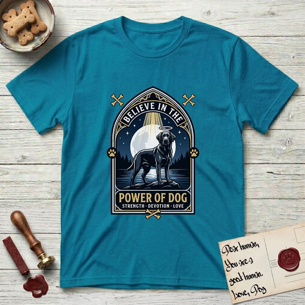 Believe in the Power of Dog Black Lab T-Shirt flat lay in Tropical Blue, featuring a dramatic gothic-arch badge with a moonlit Black Lab on a rock above still water, a beam of light through the arch, and the words Strength, Devotion, Love.