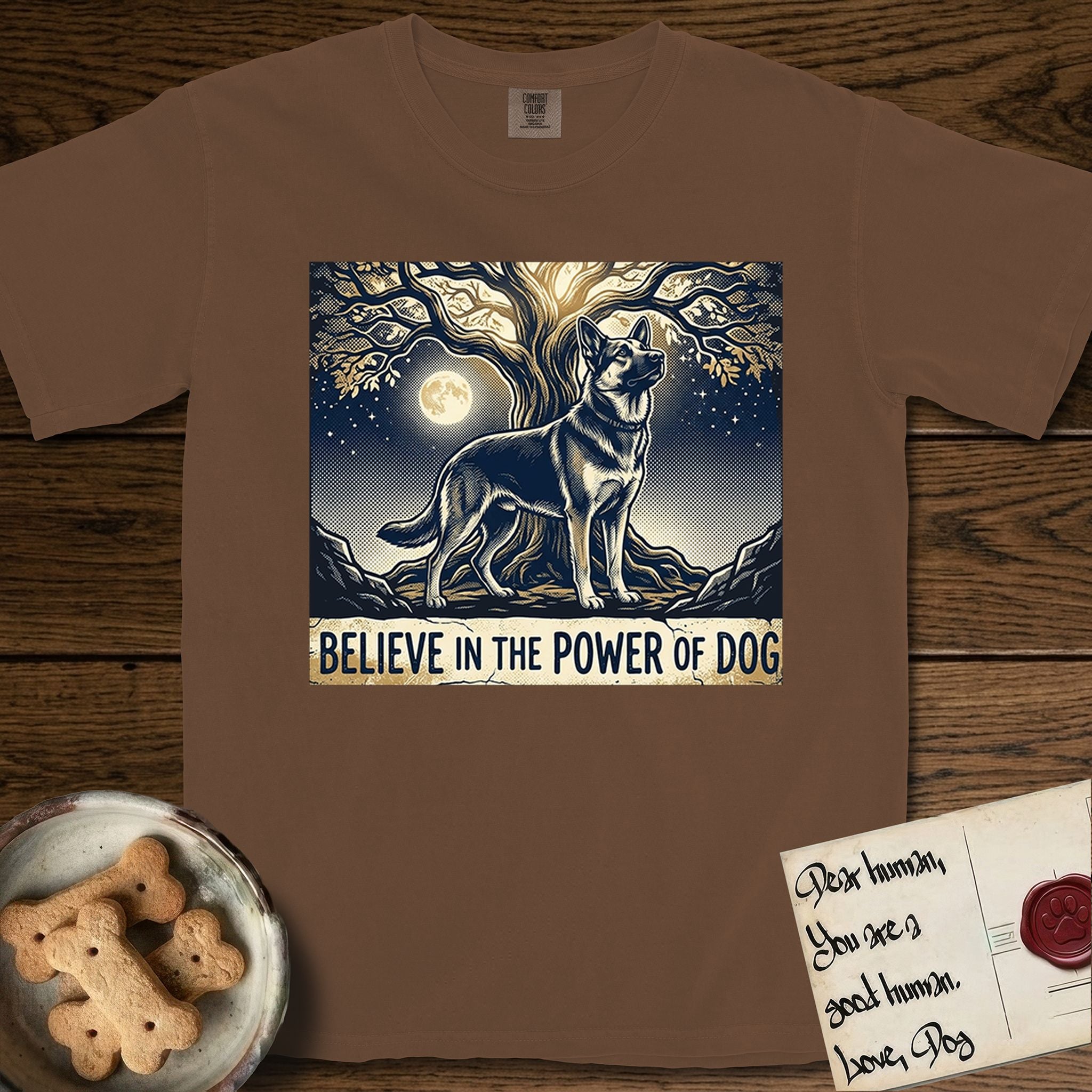 Believe in the Power of Dog German Shepherd T-Shirt flat lay in Espresso, featuring a moonlit illustration of a German Shepherd standing beneath a great tree whose roots and branches reach equally in both directions.