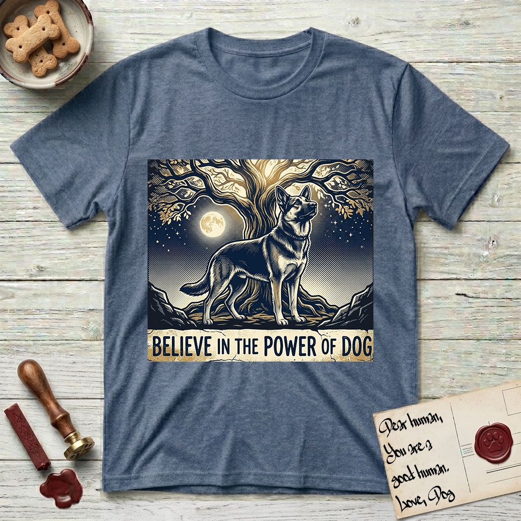 Believe in the Power of Dog German Shepherd T-Shirt flat lay in Heather Indigo, featuring a moonlit illustration of a German Shepherd standing beneath a great tree whose roots and branches reach equally in both directions.