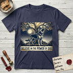 Believe in the Power of Dog German Shepherd T-Shirt flat lay in Navy, featuring a moonlit illustration of a German Shepherd standing beneath a great tree whose roots and branches reach equally in both directions.