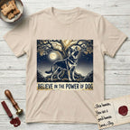 Believe in the Power of Dog German Shepherd T-Shirt flat lay in Sand, featuring a moonlit illustration of a German Shepherd standing beneath a great tree whose roots and branches reach equally in both directions.