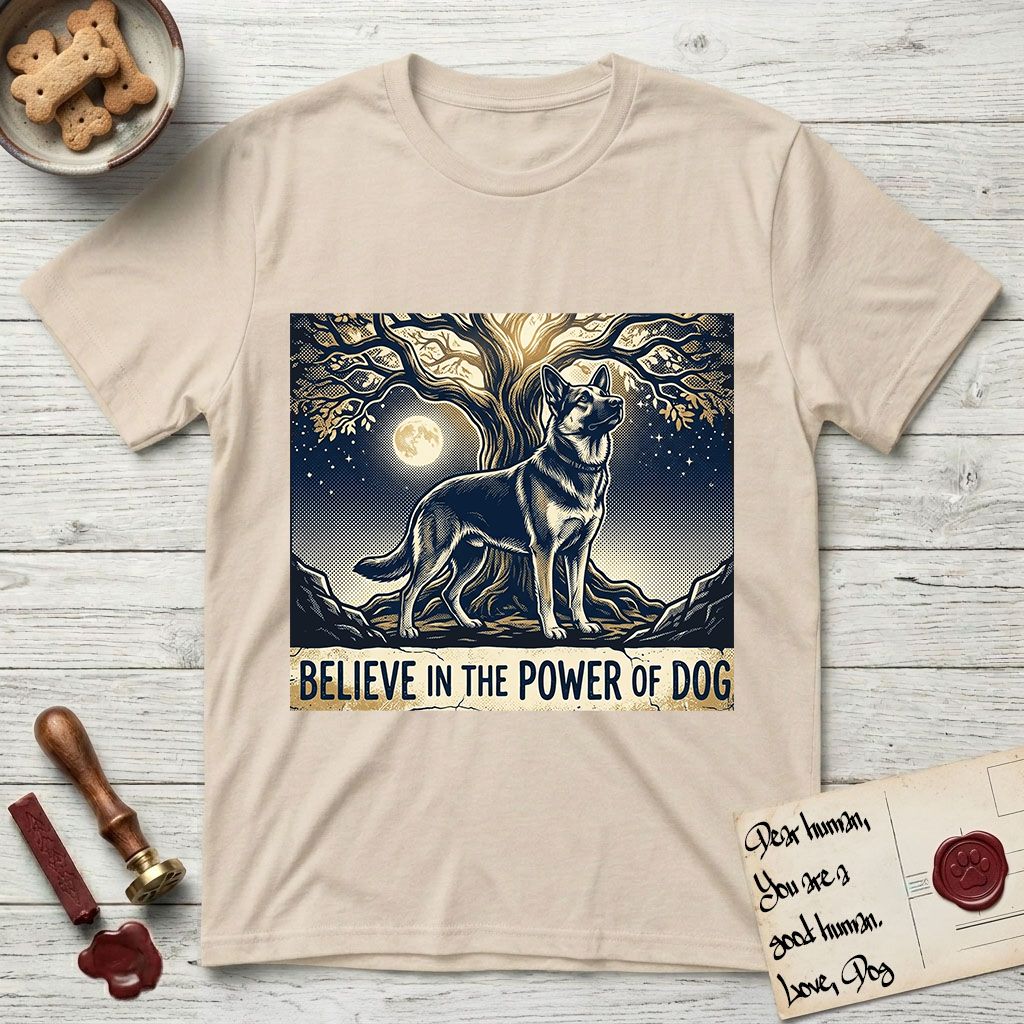 Believe in the Power of Dog German Shepherd T-Shirt flat lay in Sand, featuring a moonlit illustration of a German Shepherd standing beneath a great tree whose roots and branches reach equally in both directions.