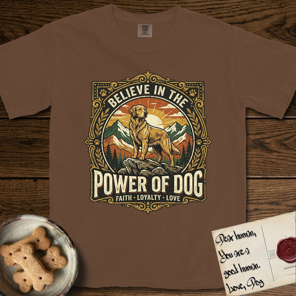 Believe in the Power of Dog Golden Retriever T-Shirt flat lay in Espresso, featuring a vintage outdoor badge with a haloed Golden Retriever standing on a rock above the treeline at sunrise and the words Faith, Loyalty, Love.