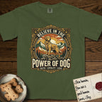 Believe in the Power of Dog Golden Retriever T-Shirt flat lay in Hemp, featuring a vintage outdoor badge with a haloed Golden Retriever standing on a rock above the treeline at sunrise and the words Faith, Loyalty, Love.