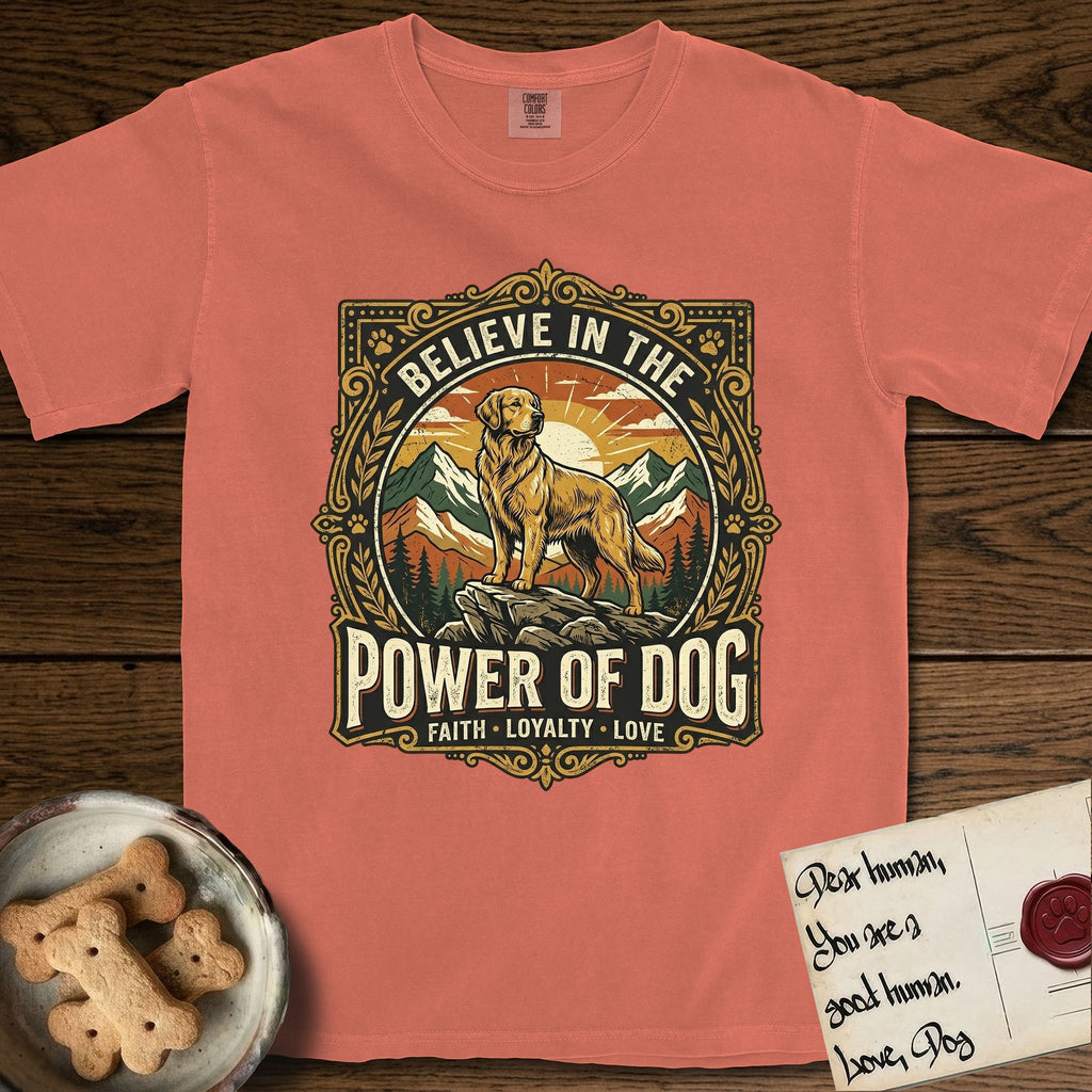 Believe in the Power of Dog Golden Retriever T-Shirt flat lay in Terracotta, featuring a vintage outdoor badge with a haloed Golden Retriever standing on a rock above the treeline at sunrise and the words Faith, Loyalty, Love.