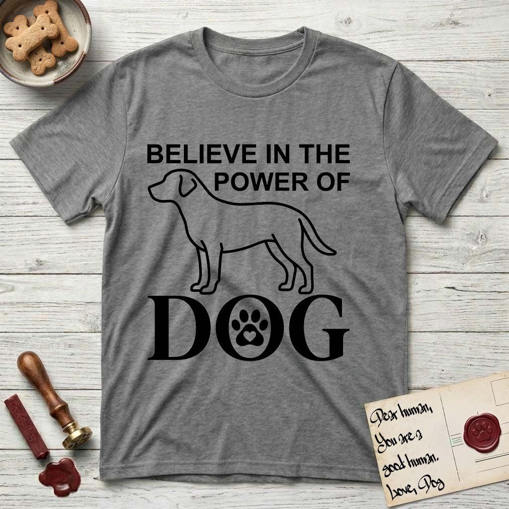 Believe in the Power of Dog Labrador T-Shirt flat lay in Graphite Heather, featuring stark minimalist single-line art of a Labrador with bold stacked "Believe in the Power of Dog" type and a paw-print heart in the O.