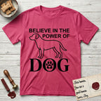 Believe in the Power of Dog Labrador T-Shirt flat lay in Heather Red, featuring stark minimalist single-line art of a Labrador with bold stacked "Believe in the Power of Dog" type and a paw-print heart in the O.