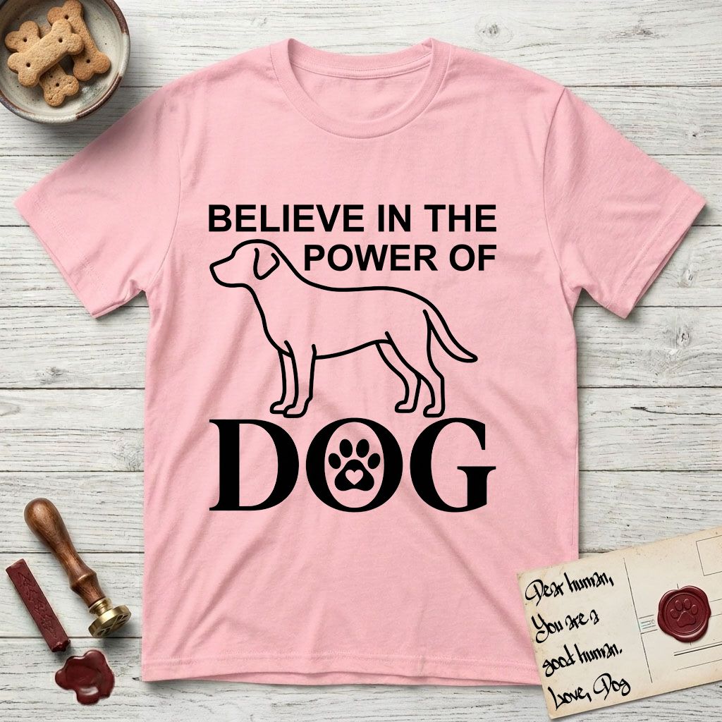 Believe in the Power of Dog Labrador T-Shirt flat lay in Light Pink, featuring stark minimalist single-line art of a Labrador with bold stacked "Believe in the Power of Dog" type and a paw-print heart in the O.