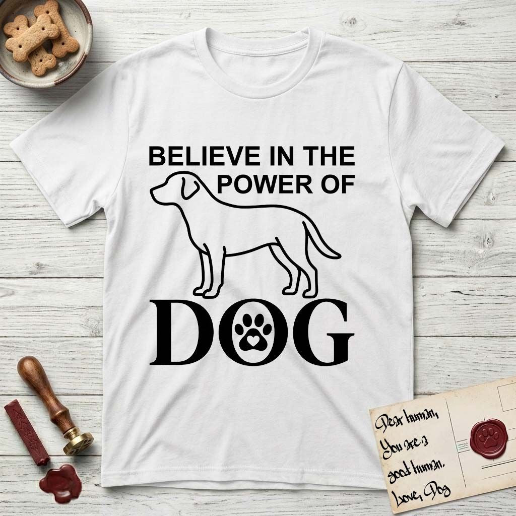Believe in the Power of Dog Labrador T-Shirt flat lay in White, featuring stark minimalist single-line art of a Labrador with bold stacked "Believe in the Power of Dog" type and a paw-print heart in the O.