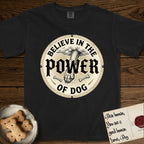 Believe in the Power of Dog Paw T-Shirt flat lay in Black, featuring a vintage engraving medallion of a Dog paw and a human hand meeting over crossed bones in a sunburst.