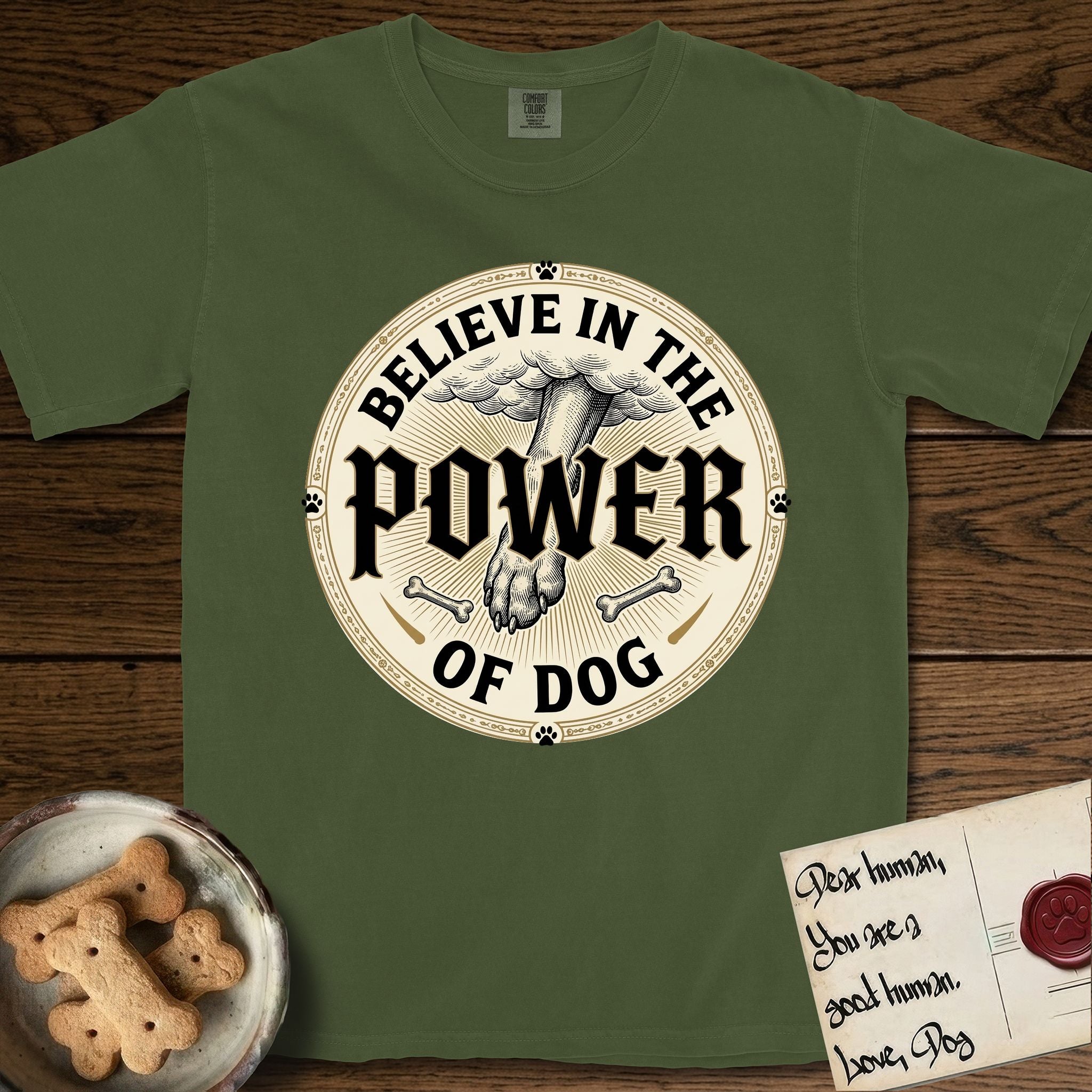 Believe in the Power of Dog Paw T-Shirt flat lay in Hemp, featuring a vintage engraving medallion of a Dog paw and a human hand meeting over crossed bones in a sunburst.