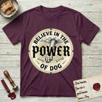 Believe in the Power of Dog Paw T-Shirt flat lay in Maroon, featuring a vintage engraving medallion of a Dog paw and a human hand meeting over crossed bones in a sunburst.