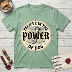 Believe in the Power of Dog Paw T-Shirt flat lay in Mint Green, featuring a vintage engraving medallion of a Dog paw and a human hand meeting over crossed bones in a sunburst.
