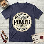 Believe in the Power of Dog Paw T-Shirt flat lay in Navy, featuring a vintage engraving medallion of a Dog paw and a human hand meeting over crossed bones in a sunburst.