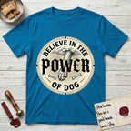 Believe in the Power of Dog Paw T-Shirt flat lay in Sapphire, featuring a vintage engraving medallion of a Dog paw and a human hand meeting over crossed bones in a sunburst.
