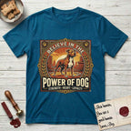 Believe in the Power of Dog Pitbull Cityscape T-Shirt flat lay in Antique Sapphire, featuring a vintage urban badge with a brick-red Pitbull, a city skyline, a radiating sun, and the words Strength, Heart, Loyalty.