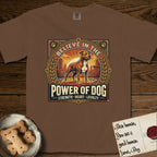Believe in the Power of Dog Pitbull T-Shirt flat lay in Espresso, featuring a vintage urban badge with a brick-red Pitbull, a city skyline, a radiating sun, and the words Strength, Heart, Loyalty.