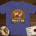 Believe in the Power of Dog Pitbull T-Shirt flat lay in Grape, featuring a vintage urban badge with a brick-red Pitbull, a city skyline, a radiating sun, and the words Strength, Heart, Loyalty.