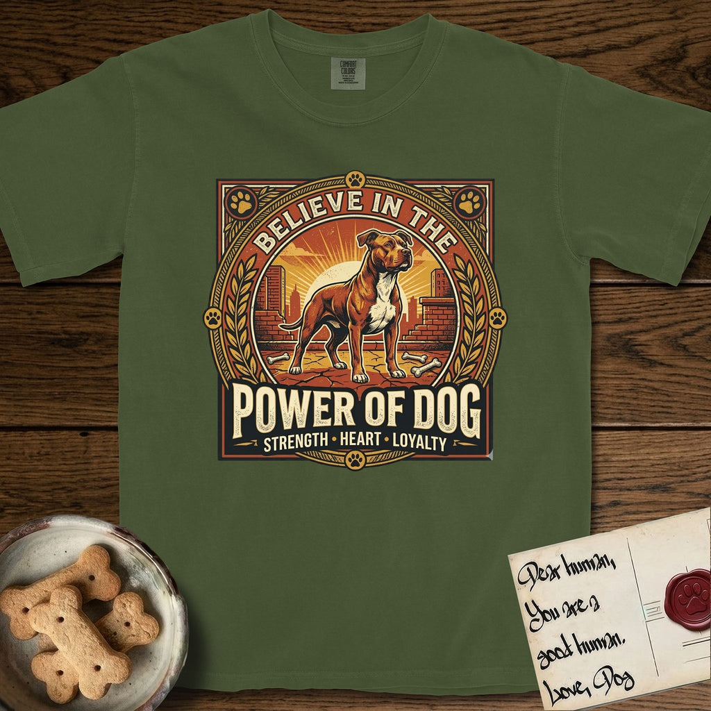 Believe in the Power of Dog Pitbull T-Shirt flat lay in Hemp, featuring a vintage urban badge with a brick-red Pitbull, a city skyline, a radiating sun, and the words Strength, Heart, Loyalty.