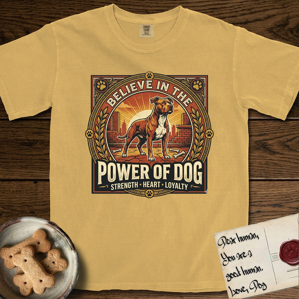Believe in the Power of Dog Pitbull T-Shirt flat lay in Mustard, featuring a vintage urban badge with a brick-red Pitbull, a city skyline, a radiating sun, and the words Strength, Heart, Loyalty.