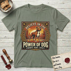 Believe in the Power of Dog Pitbull Cityscape T-Shirt flat lay in Sage, featuring a vintage urban badge with a brick-red Pitbull, a city skyline, a radiating sun, and the words Strength, Heart, Loyalty.