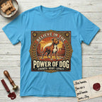 Believe in the Power of Dog Pitbull Cityscape T-Shirt flat lay in Sky, featuring a vintage urban badge with a brick-red Pitbull, a city skyline, a radiating sun, and the words Strength, Heart, Loyalty.