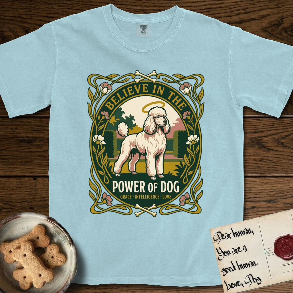 Believe in the Power of Dog Poodle T-Shirt flat lay in Chambray, featuring an Art Nouveau floral badge with a haloed Poodle in a garden park scene and the words Grace, Intelligence, Love.