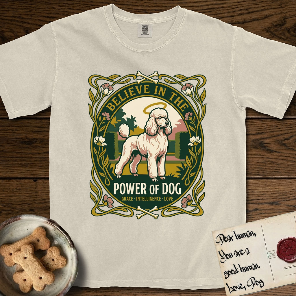 Believe in the Power of Dog Poodle T-Shirt flat lay in Ivory, featuring an Art Nouveau floral badge with a haloed Poodle in a garden park scene and the words Grace, Intelligence, Love.
