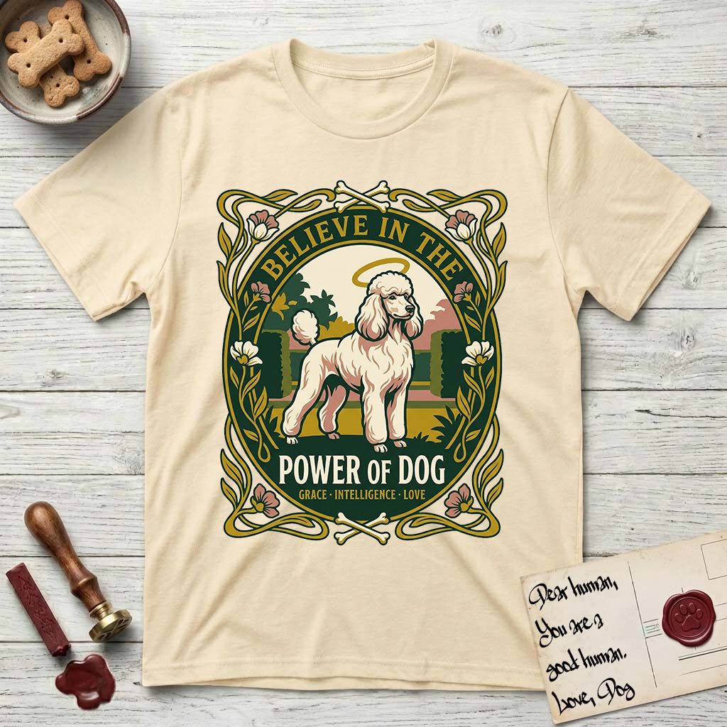 Believe in the Power of Dog Poodle T-Shirt flat lay in Natural, featuring an Art Nouveau floral badge with a haloed Poodle in a garden park scene and the words Grace, Intelligence, Love.