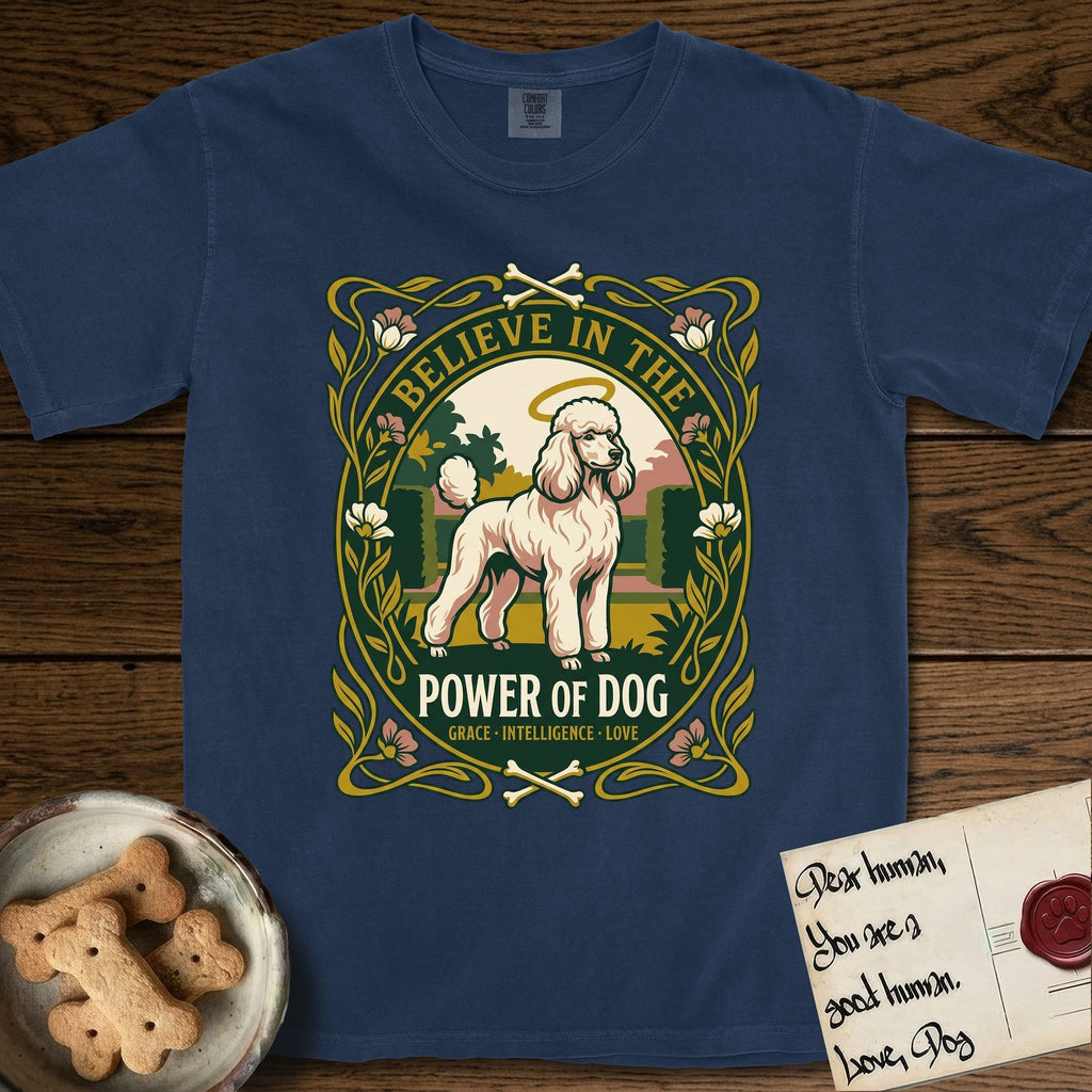 Believe in the Power of Dog Poodle T-Shirt flat lay in True Navy, featuring an Art Nouveau floral badge with a haloed Poodle in a garden park scene and the words Grace, Intelligence, Love.