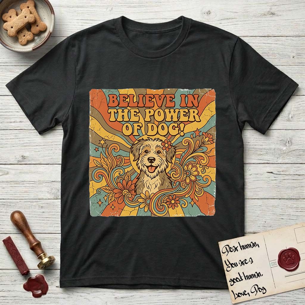 Believe in the Power of Dog Rescue Mutt T-Shirt flat lay in Black, featuring a retro 1970s groovy poster of a grinning rescue mutt with a radiating sunburst and swirling florals.