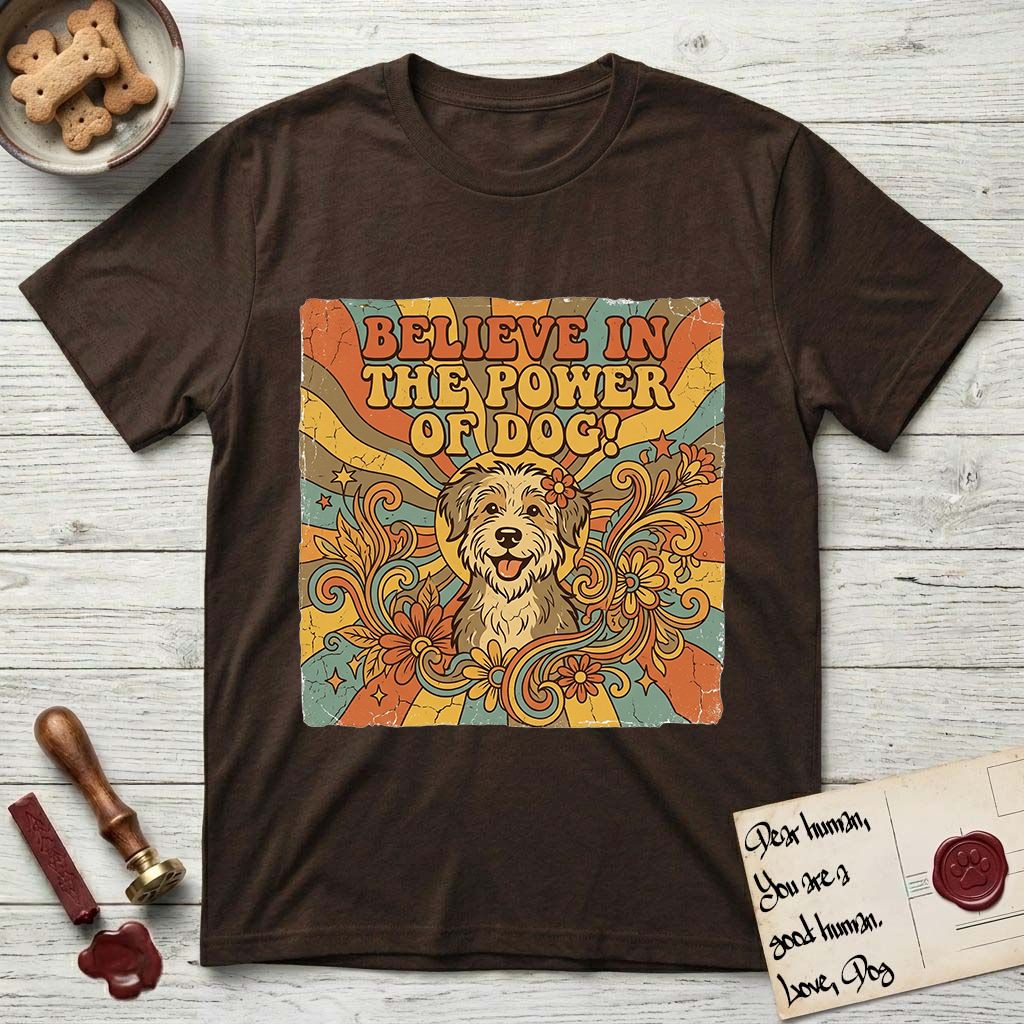 Believe in the Power of Dog Rescue Mutt T-Shirt flat lay in Dark Chocolate, featuring a retro 1970s groovy poster of a grinning rescue mutt with a radiating sunburst and swirling florals.
