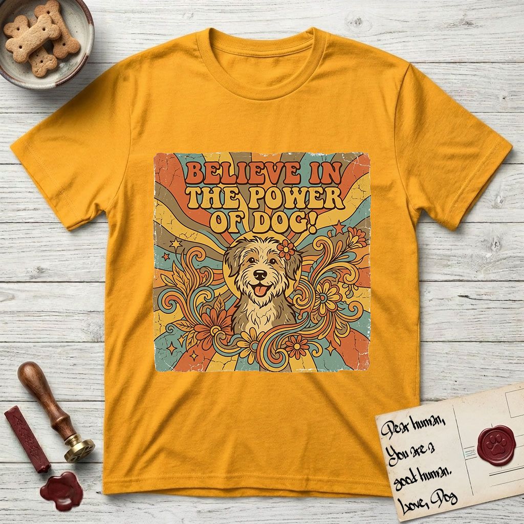 Believe in the Power of Dog Rescue Mutt T-Shirt flat lay in Gold, featuring a retro 1970s groovy poster of a grinning rescue mutt with a radiating sunburst and swirling florals.