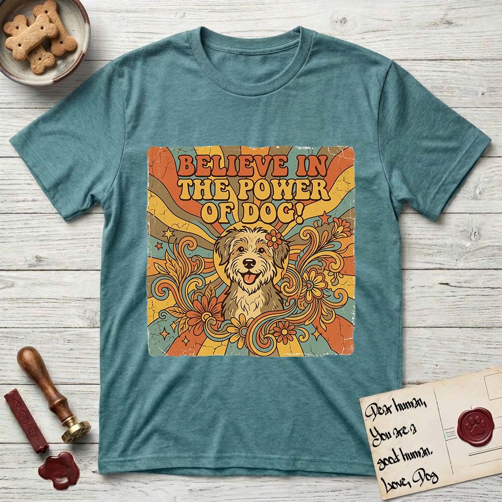 Believe in the Power of Dog Rescue Mutt T-Shirt flat lay in Heather Galapagos Blue, featuring a retro 1970s groovy poster of a grinning rescue mutt with a radiating sunburst and swirling florals.