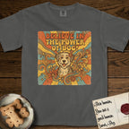 Believe in the Power of Dog Rescue Mutt T-Shirt flat lay in Pepper, featuring a retro 1970s groovy poster of a grinning rescue mutt with a radiating sunburst and swirling florals.