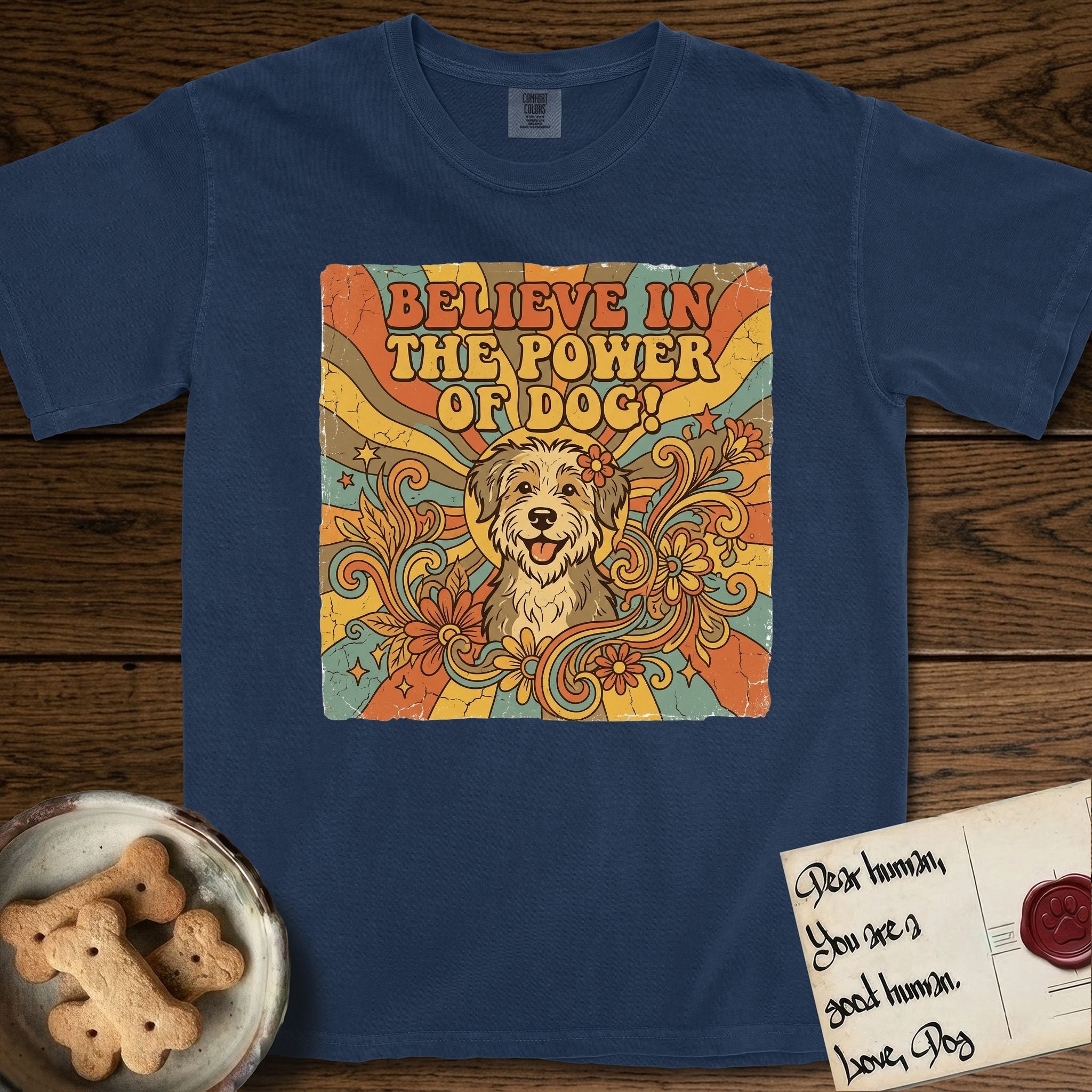 Believe in the Power of Dog Rescue Mutt T-Shirt flat lay in True Navy, featuring a retro 1970s groovy poster of a grinning rescue mutt with a radiating sunburst and swirling florals.
