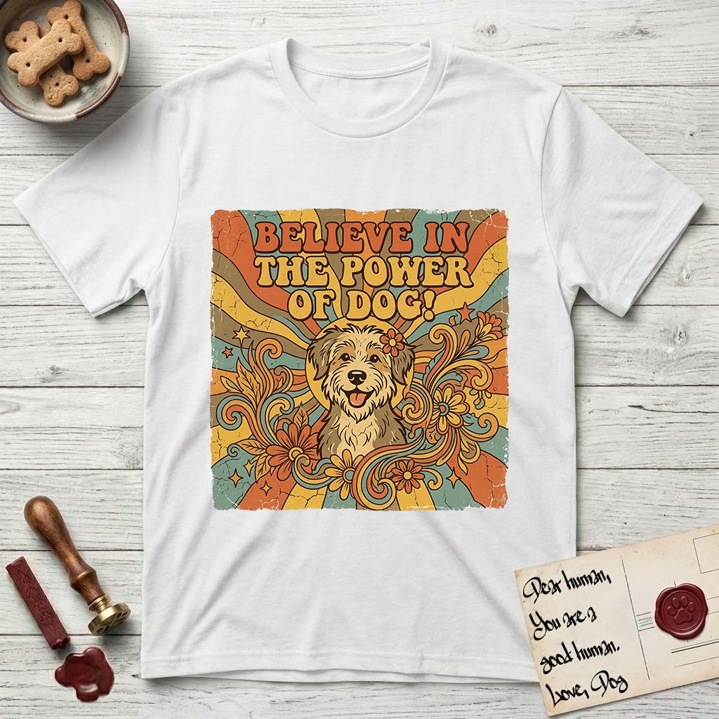Believe in the Power of Dog Rescue Mutt T-Shirt flat lay in White, featuring a retro 1970s groovy poster of a grinning rescue mutt with a radiating sunburst and swirling florals.