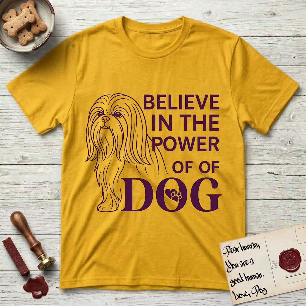 Believe in the Power of Dog Shih Tzu Line Drawing T-Shirt flat lay in Daisy, featuring a clean single-color line drawing of a long-coated Shih Tzu beside the stacked words Believe in the Power of Dog with a paw print pressed into the O.