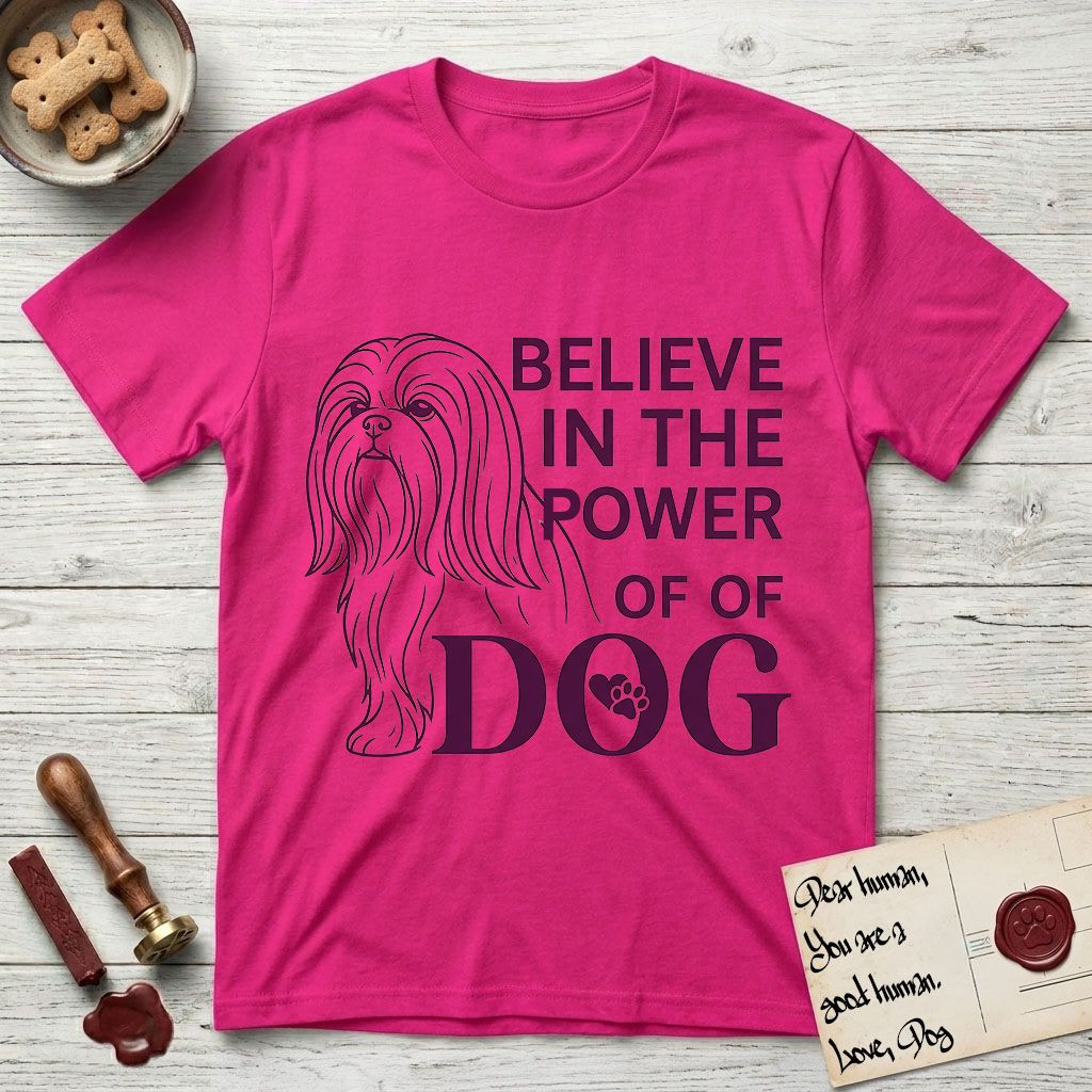 Believe in the Power of Dog Shih Tzu Line Drawing T-Shirt flat lay in Heliconia, featuring a clean single-color line drawing of a long-coated Shih Tzu beside the stacked words Believe in the Power of Dog with a paw print pressed into the O.