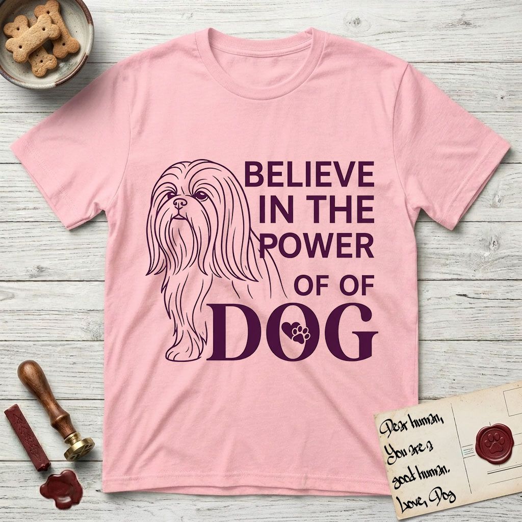 Believe in the Power of Dog Shih Tzu Line Drawing T-Shirt flat lay in Light Pink, featuring a clean single-color line drawing of a long-coated Shih Tzu beside the stacked words Believe in the Power of Dog with a paw print pressed into the O.