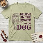 Believe in the Power of Dog Shih Tzu Line Drawing T-Shirt flat lay in Pistachio, featuring a clean single-color line drawing of a long-coated Shih Tzu beside the stacked words Believe in the Power of Dog with a paw print pressed into the O.