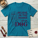 Believe in the Power of Dog Shih Tzu Line Drawing T-Shirt flat lay in Tropical Blue, featuring a clean single-color line drawing of a long-coated Shih Tzu beside the stacked words Believe in the Power of Dog with a paw print pressed into the O.
