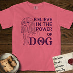 Believe in the Power of Dog Shih Tzu T-Shirt flat lay in Watermelon, featuring a clean single-color line drawing of a long-coated Shih Tzu beside the stacked words Believe in the Power of Dog with a paw print pressed into the O.