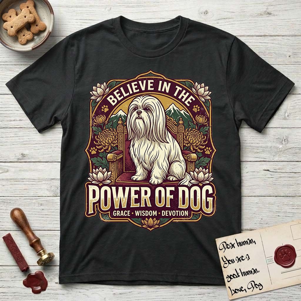Believe in the Power of Dog Shih Tzu Throne T-Shirt flat lay in Black, featuring an ornate dark badge with a Shih Tzu seated on a throne among chrysanthemums, lotus blossoms and mountain landscapes, and the words Grace, Wisdom, Devotion.