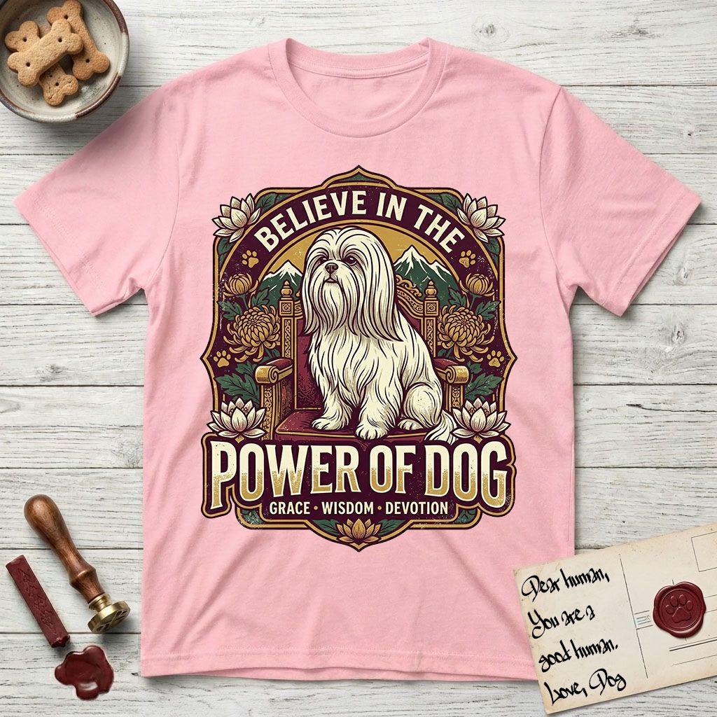 Believe in the Power of Dog Shih Tzu Throne T-Shirt flat lay in Light Pink, featuring an ornate dark badge with a Shih Tzu seated on a throne among chrysanthemums, lotus blossoms and mountain landscapes, and the words Grace, Wisdom, Devotion.