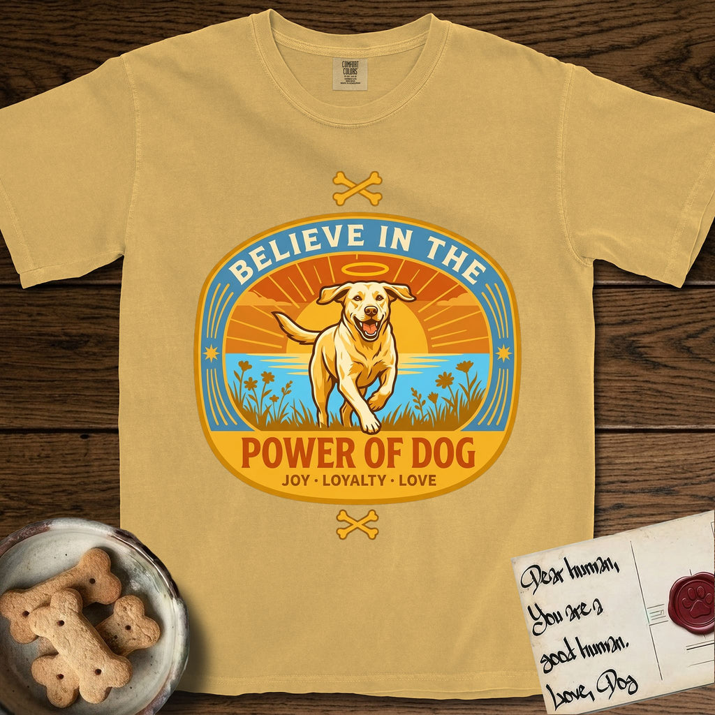 Believe in the Power of Dog Yellow Lab T-Shirt flat lay in Mustard, featuring a vintage oval badge with a haloed Yellow Lab running through a field of wildflowers and the words Joy, Loyalty, Love.